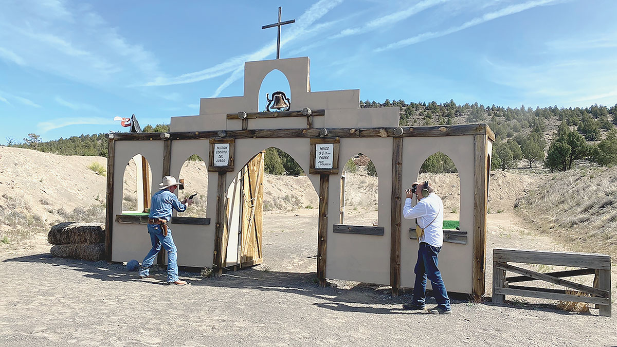 The Single Action Shooting Society church facade at Central Oregon Shooting Sports Association (COSSA). Gary using camera.